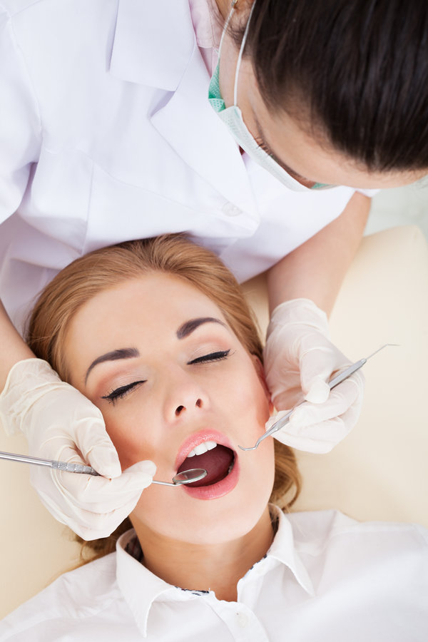 High Angle View Of A Woman Having Her Dental Checkup